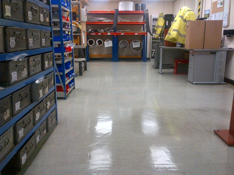 Before & after photo of a vinyl factory floor strip & re-seal